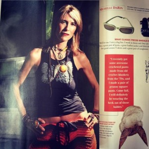 Stylish woman posing confidently in casual urban wear with layered necklaces.