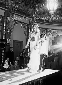 Fashion show with models walking on runway.