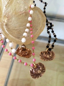 Handcrafted jewelry with intricate rose designs and colorful beaded necklaces.