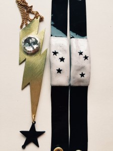 Stylish outfit with star-patterned sleeves and bold lightning bolt accessory.