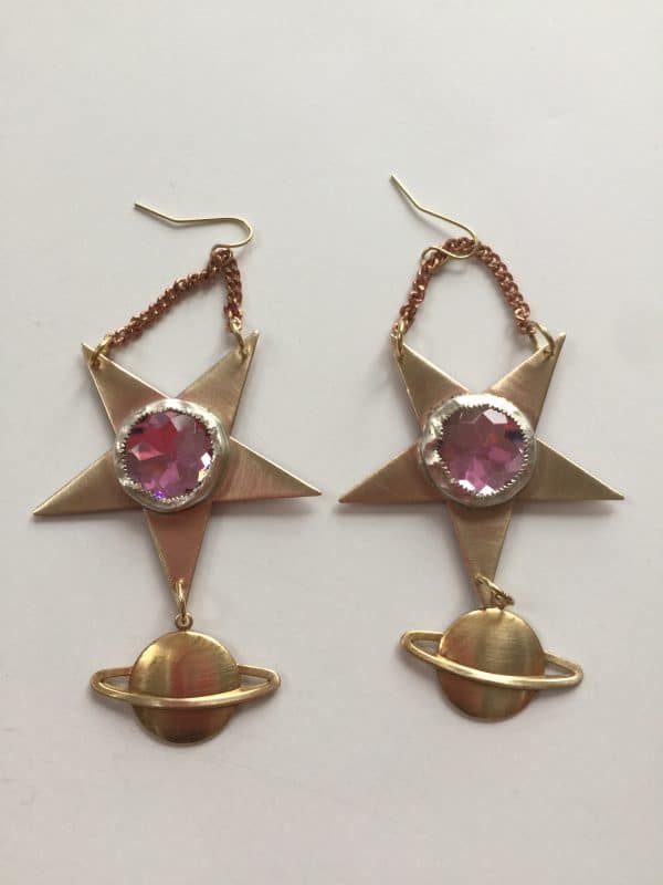 Star-shaped earrings with purple gems and gold planet charms.