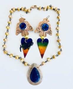 Colorful handcrafted jewelry with bird and heart motifs.