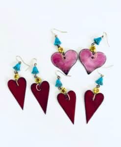 Two pairs of heart-shaped earrings with colorful beads.