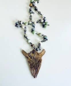 A beaded necklace with a pendant shaped like an animal skull.