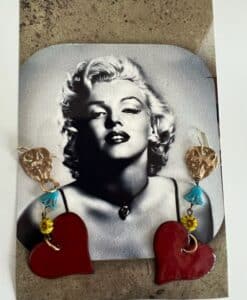 Black and white photo of Marilyn Monroe with heart-shaped earrings.
