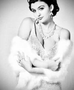 Black and white portrait of a glamorous woman in vintage attire with a fur stole.