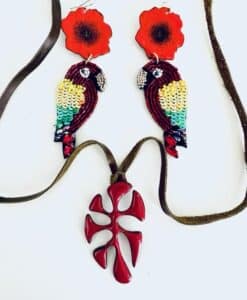 Colorful parrot earrings with red flower tops and a red pendant necklace.