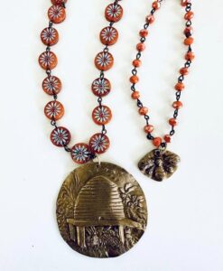 Two beaded necklaces with a large medallion and a smaller pendant.