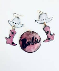 Barbie-themed earrings with cowboy hats and pink boots.