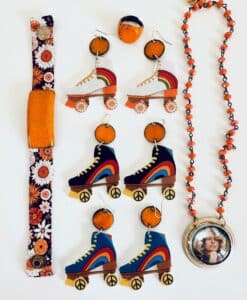 Colorful roller skate earrings and 70s-inspired accessories with floral and peace motifs.