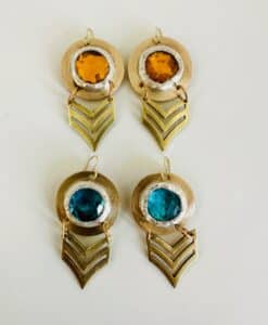 Two pairs of circular earrings with amber and teal stones and gold chevron dangles.