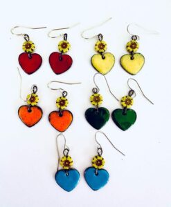 Colorful heart-shaped earrings with sunflower accents in red, yellow, orange, green, and blue.
