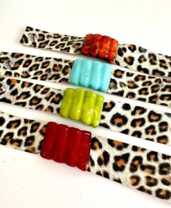 Colorful ceramic beads on leopard print fabric strips.