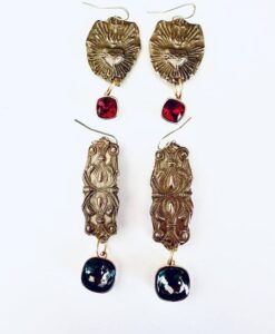 Intricately designed gold-tone earrings with red and black gemstone-like accents.
