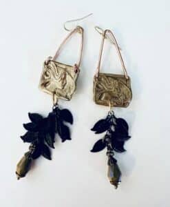 Unique earrings with gold squares and black leaf and bead dangles.