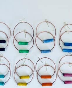 Colorful hoop earrings with cylindrical beads arranged in pairs.