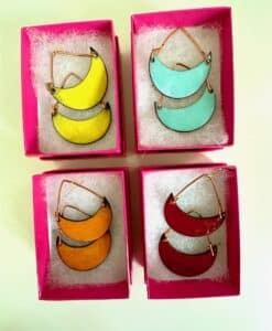 Colorful crescent-shaped earrings in pink boxes.