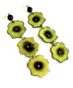 Dangle earrings with green and black floral designs.