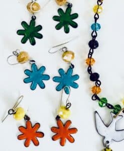 Colorful flower-shaped earrings and a beaded necklace with a bird charm.