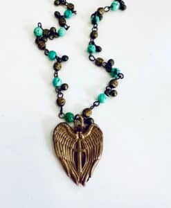 Bronze angel wing pendant necklace with turquoise and brass beads.