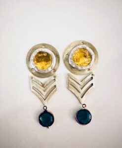 Unique earrings with yellow and green stones and silver geometric designs.