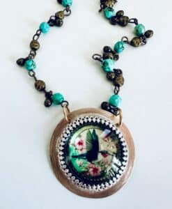 Handcrafted necklace with turquoise beads and hummingbird pendant.