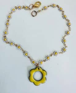 Necklace with small white daisies and a large yellow flower pendant.