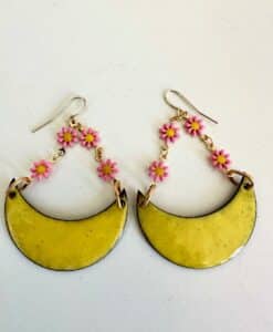 Yellow crescent earrings with pink flower chains.
