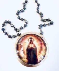 Rosary beads with a glowing image of the Virgin Mary at the center.