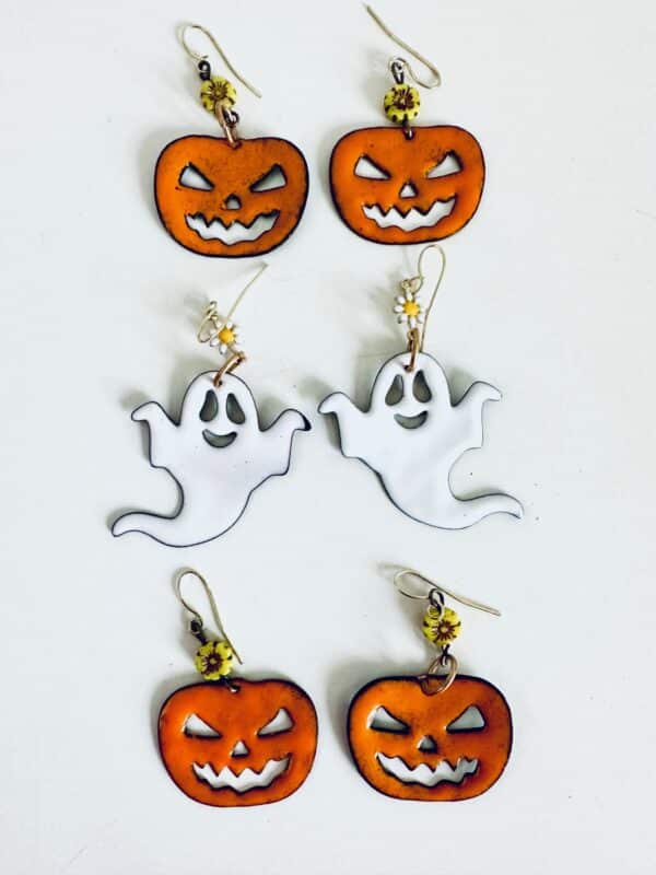Halloween-themed earrings with pumpkins and ghosts.