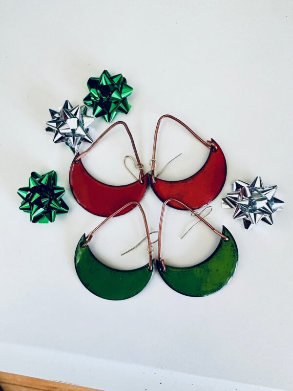 Festive red and green crescent-shaped earrings with metallic gift bows.