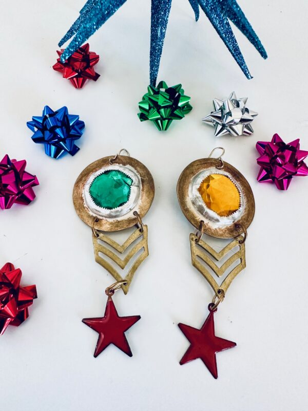 Vintage earrings with colorful bows and star charms on white background.