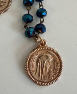 Gold Marian medal with blue rosary beads