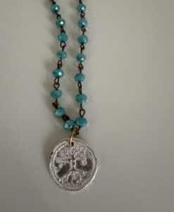 Turquoise beaded necklace with silver coin pendant
